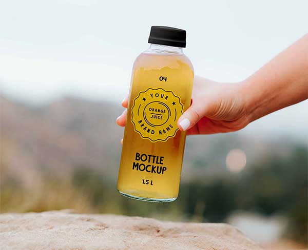 Free Transparent Bottle in Hand Mockup